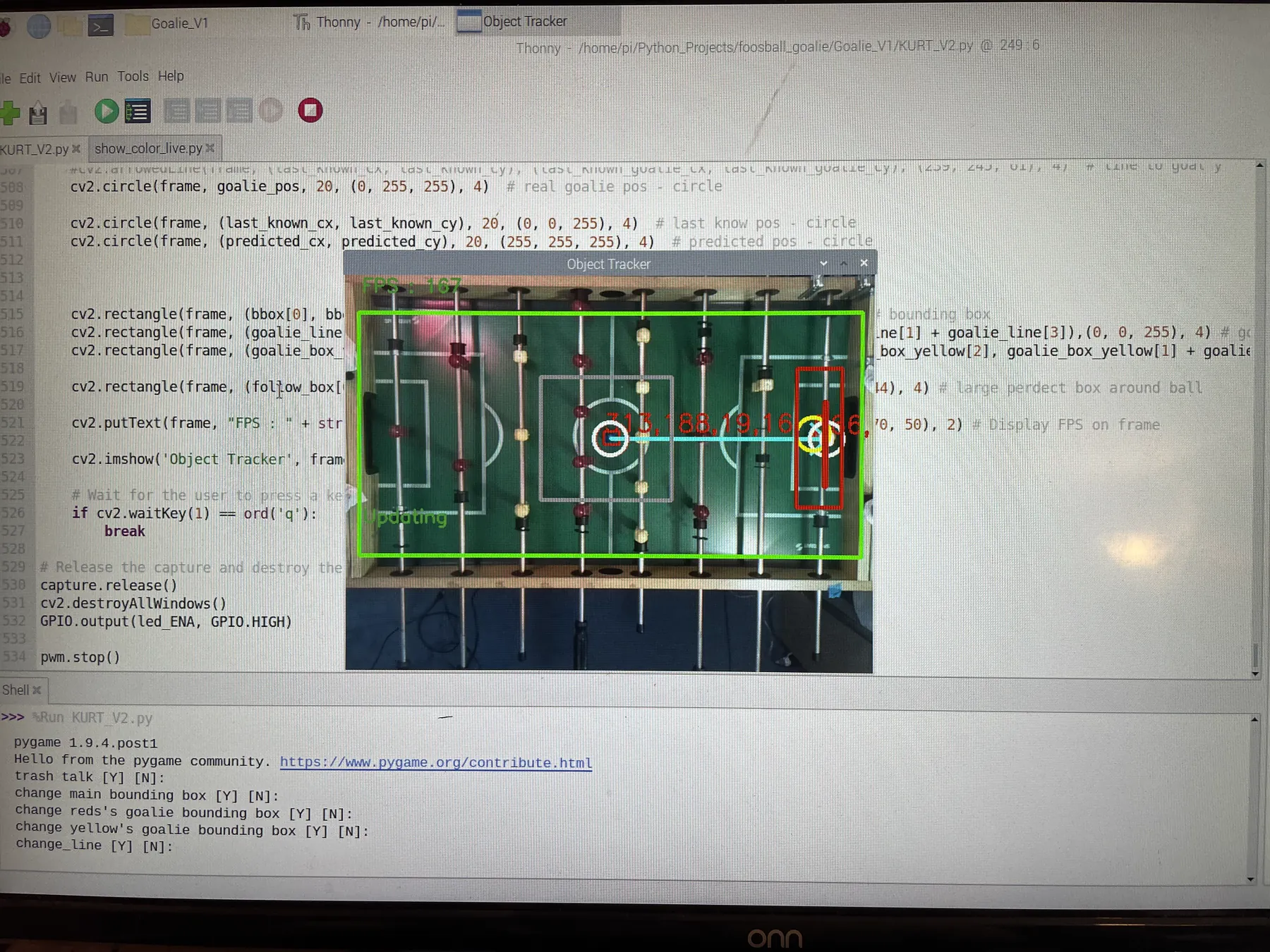 A monitor showing the KURT_V2.py source in the Thonny editor beside the OpenCV 'Object Tracker' window, where the overhead view of the table is marked up with a green bounding box, the ball circled in red with its coordinates, and a red box around the goalie